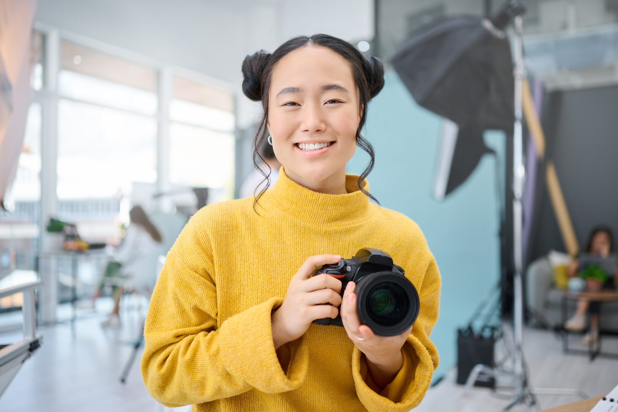 Smile, camera and portrait of a photographer working at a studio for a photoshoot. Happy, media and